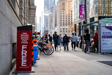 Fototapeta premium Street Box Media newspaper rack on a busy sidewalk. Toronto, Canada - April 29, 2024.