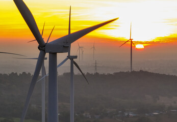 Wind farm field and sunset sky. Wind power. Sustainable, renewable energy. Wind turbines generate electricity. Sustainable development. Green technology for energy sustainability. Eco-friendly energy.