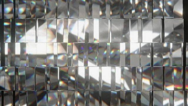 A wall of glass blocks reflects and refracts light, creating vibrant rainbow hues and dynamic patterns in an abstract visual display.