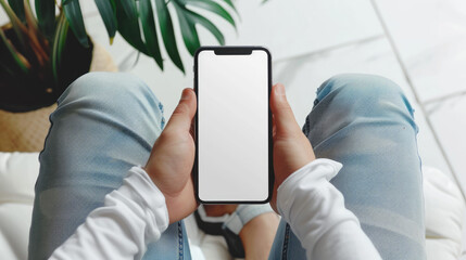 man with jeans sit and playing smartphone, white empty mockup screen smartphone