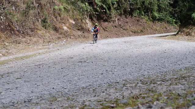 cyclist on mountain bike descends Yungas Rd, Bolivian Death Road