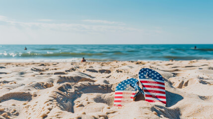 American flag flip flops on sandy beach with ocean backdrop