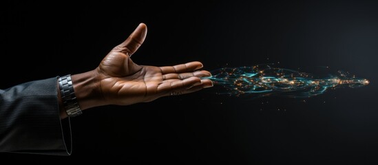 Close-up image of human hand gesturing with finger on black background