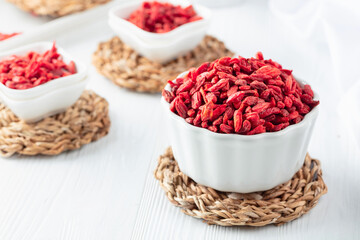 Dried goji berries on a white table.
