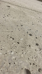 A close up of a concrete surface with many small holes