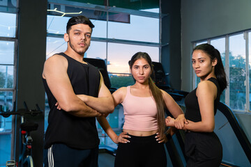 Fototapeta premium Portrait Group of three confident, fit young indian friends workout together in gym. athletes, fitness, sports, healthy lifestyle.