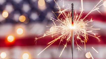 Sparkler in front of American flag blurred background