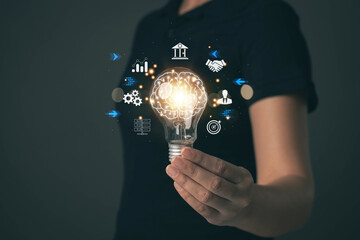 Light bulb in hand. Concept of finding business ideas. Finding information from internet technology. Banking, finance, investment and business.
