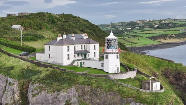 Blackhead Lighthouse near seaside town Whitehead in County Antrim, Northern Ireland. Aerial 50fps UHD