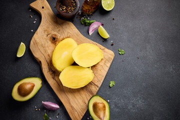 Sliced mango on a wooden cutting board at domestic kitchen