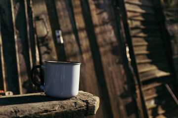 a cup of hot drink on a wooden table on a sunny day