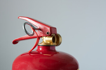 Fire extinguisher isolated on a gray background. Close-up.