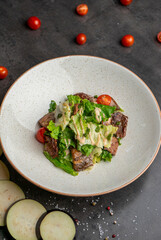 Warm salad with beef tender sauce and cherry tomatoes