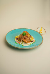 fish in cream sauce with vegetables on background
