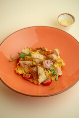 pasta with chicken in creamy sauce and cherry tomatoes