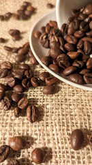 Coffee beans around a white upside down cup