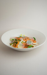 salad with radishes and salmon on a gray background