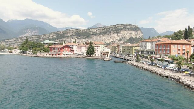Aerial view of lake promenade in Torbole on Lake Garda with cars on the road on the lake on a sunny day