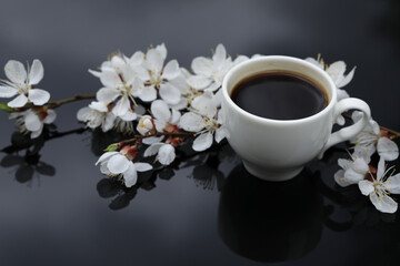Cup of hot black coffee. Morning coffee with flowers. Romantic morning