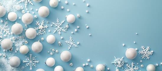 Christmas or winter arrangement featuring a design composed of white balls and snowflakes on a soft blue backdrop. Emphasizing the themes of Christmas, winter, and the new year.