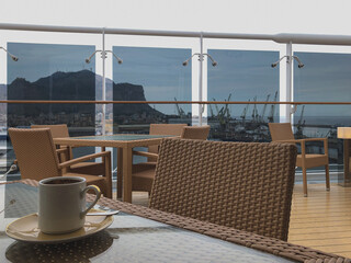 Deck chairs and sun loungers on outdoor swimmingpool pool deck with panoramic ocean views on modern...