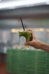 Closeup of Iced Caramel Macchiato at the coffee shop, Caramel Macchiato is a classic macchiato beverage. It consists of vanilla syrup, espresso, steamed milk, foam, and caramel drizzle