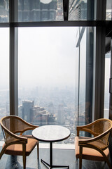 interior of cafe with elevated view of urban landscape in bangkok, thailand