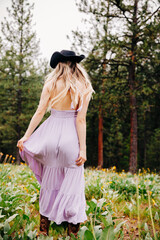 Teenage girl in western boho sundress with black hat