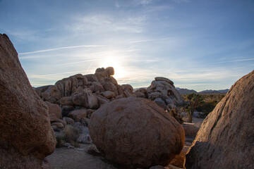 Sunburst through desert rocks at sunrise