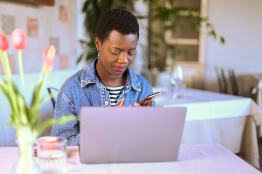 business woman use cell smart phone while sitting at bistro