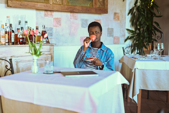 young short haired african woman have espresso coffee