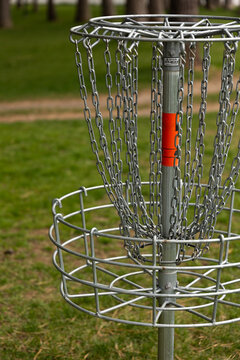 Disc golf basket in park setting