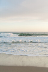 Gentle waves caress the beach at peaceful dusk