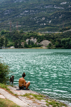 Woman with dog close on a lake