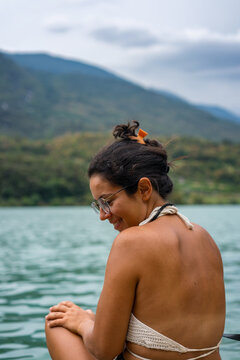 Woman looking to the side with a bikini on a lake