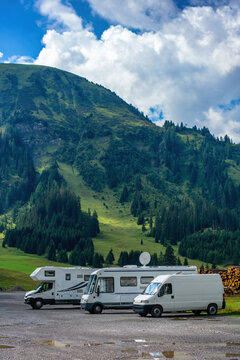 Camper van and motorhomes parked on a mountain landscape