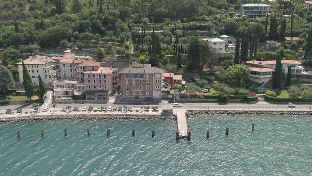 Aerial view of lake promenade on Lake Garda with houses in the background and cars on the road  on a sunny day