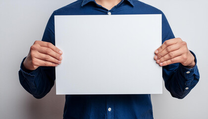 Closeup of hands holding a white blank cardboard, mockup