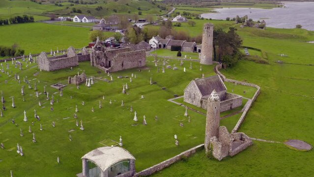 Dynamic aerial descends towards Clonmacnoise ancient ruins. County Offaly