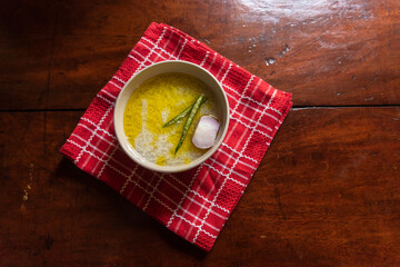 Panta bhat or pakhala or fermented rice soup with water, green chillies and onion in a bowl. Staple food in Eastern India.