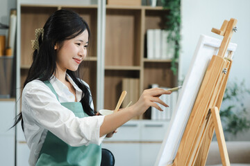 artist painting on canvas in the home studio, fine arts and creativity concept.