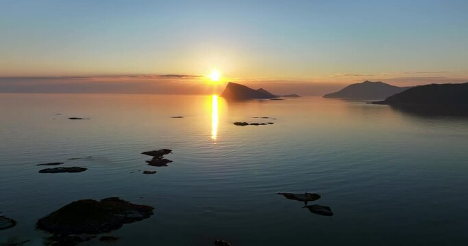 Midnight sun and calm sea, serene summer night, in Northern Norway - Aerial view