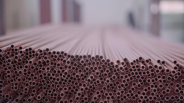 Stack of Copper tubes for heat exchangers. Lots of pipes to produce. Heating element. Factory production.