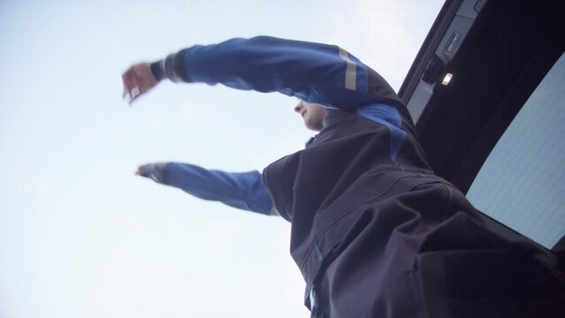 Close upwards view as ice diver puts on dry suit before penetration dive