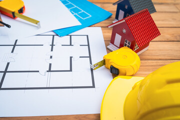 Top view desk of Engineer tools meticulously designs structures at desk, referring to blueprints...