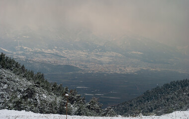 Beyond the fog, the heart of Bursa, Uludag in the distance, top view of Bursa from Ericek village

