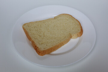 One slice of white bread, on white plate, isolated on white background