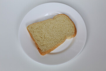 One slice of white bread, on white plate, isolated on white background