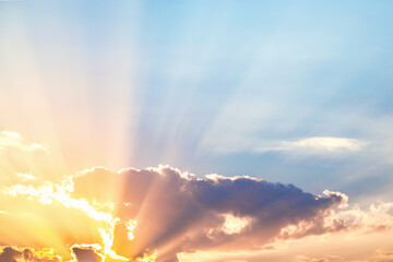 Breathtaking sunrise with radiant sunbeams piercing through clouds, ideal for vibrant and hopeful...