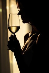 A woman holding a glass of wine. Suitable for lifestyle and leisure concepts